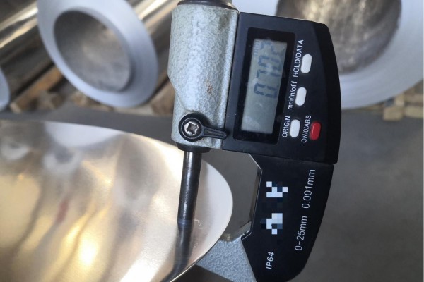 Độ dày của tấm nhôm đang được đo.